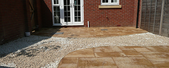 A back garden with paving and stone features
